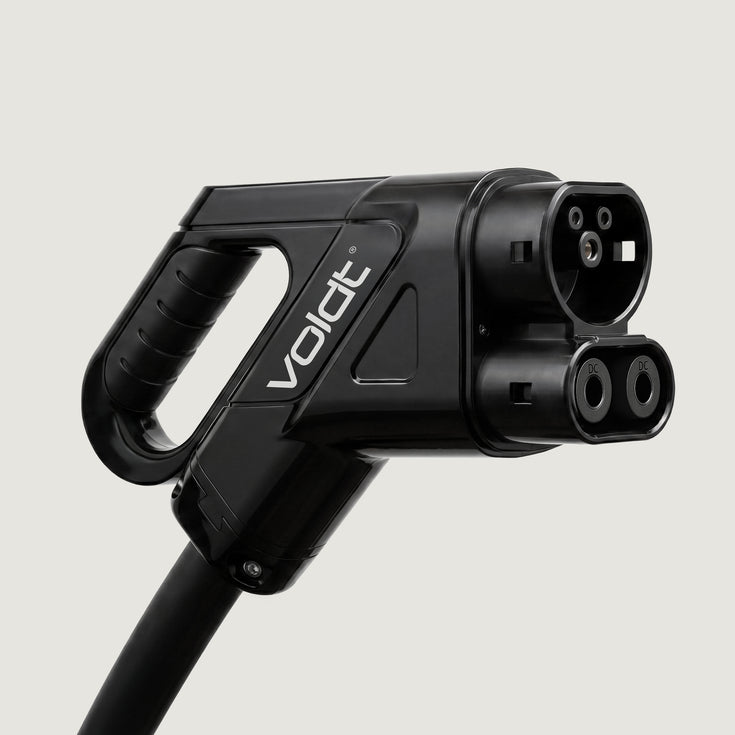 Close-up of a CCS2 DC fast charging connector with ergonomic handle
