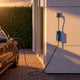 Electric car parked at home charging at dusk with the Voldt® Type 1 Portable Charger